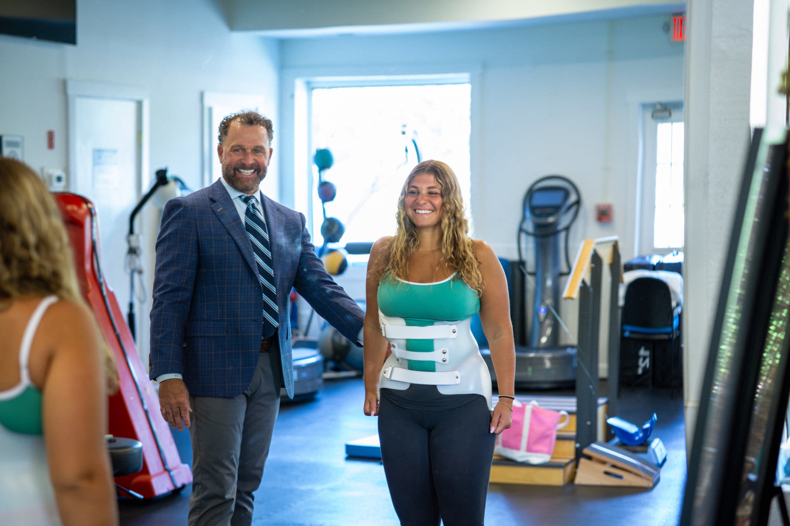 Scoliosis specialist and patient smiling together after a brace fitting